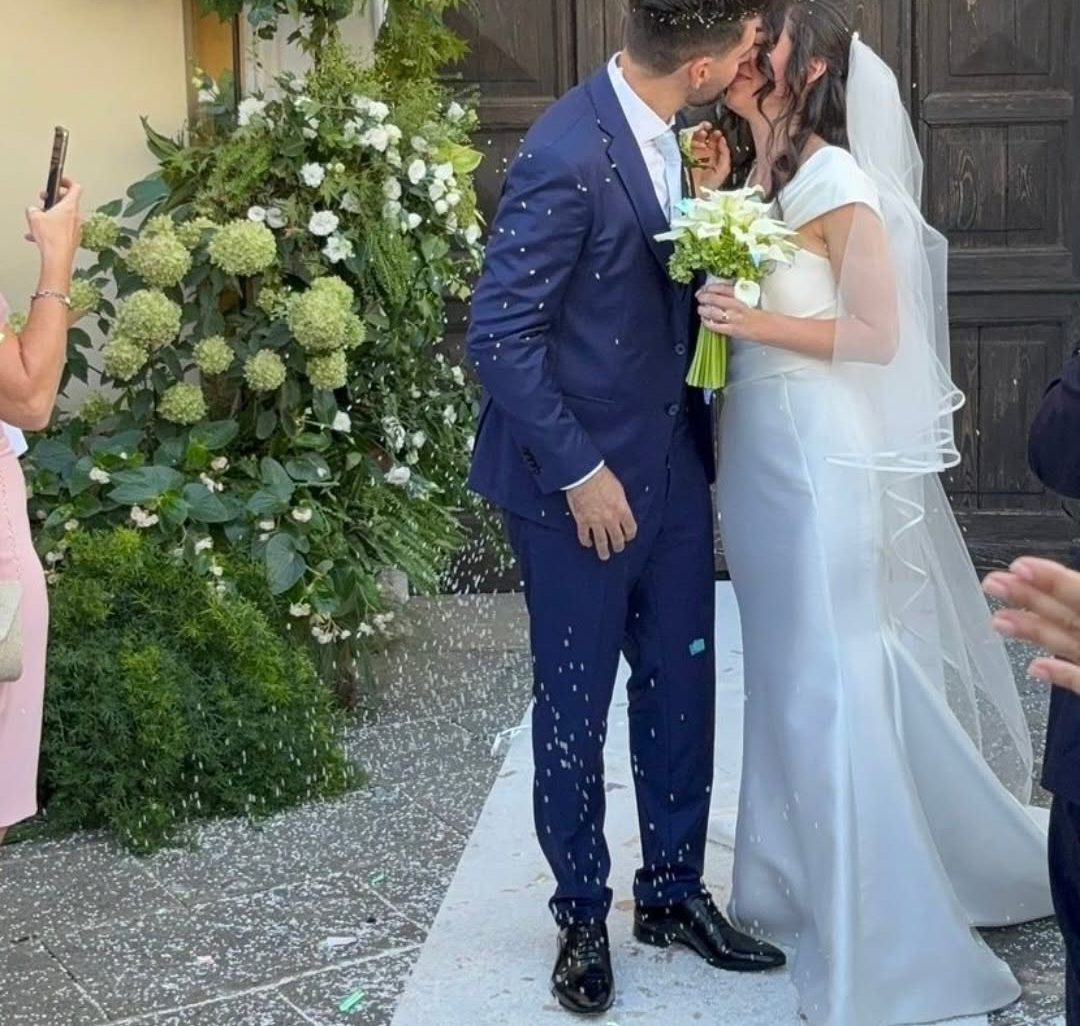 Gli sposi davanti alla chiesa, accanto a una composizione di ortensie bianche